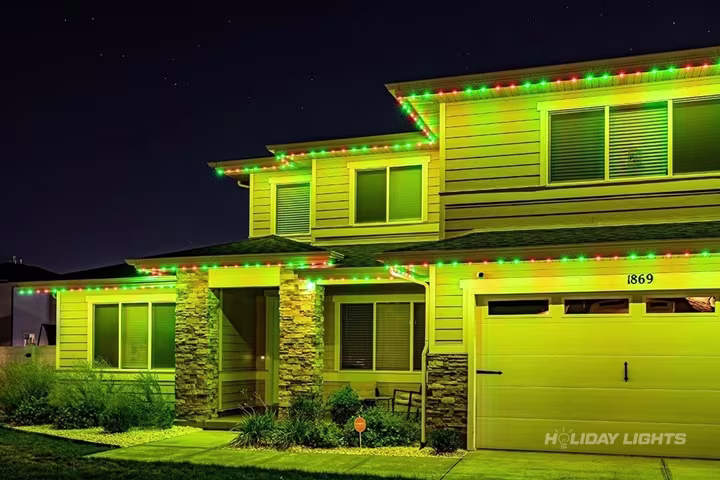 Permanent roofline lights installed along the full eaves of a Delaware home